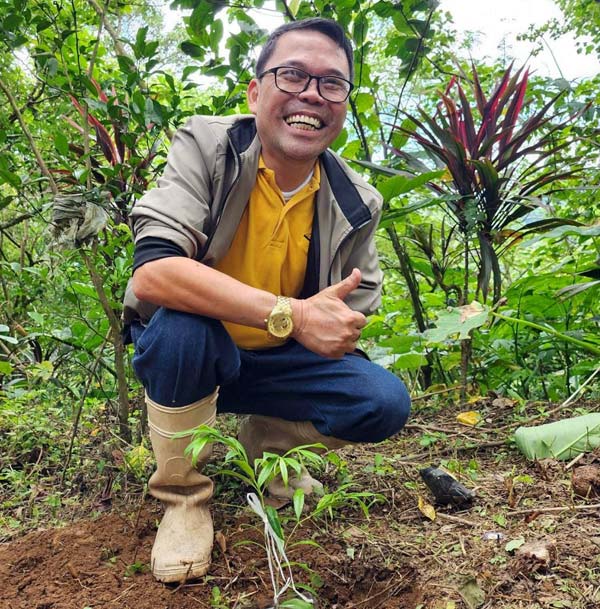 Farmer Working on an Agarwood Seedling and Surrounded by Agarwood Trees and Their Distinctive Fragrance